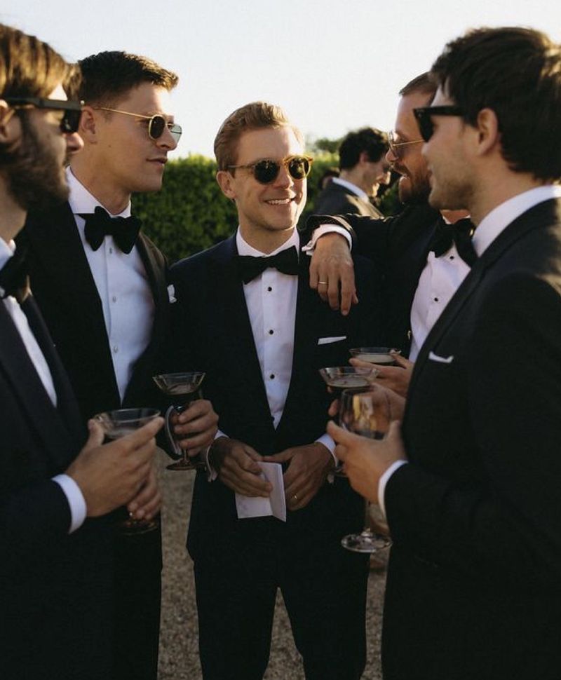 gentlemen in black tie and sunglasses at golden hour