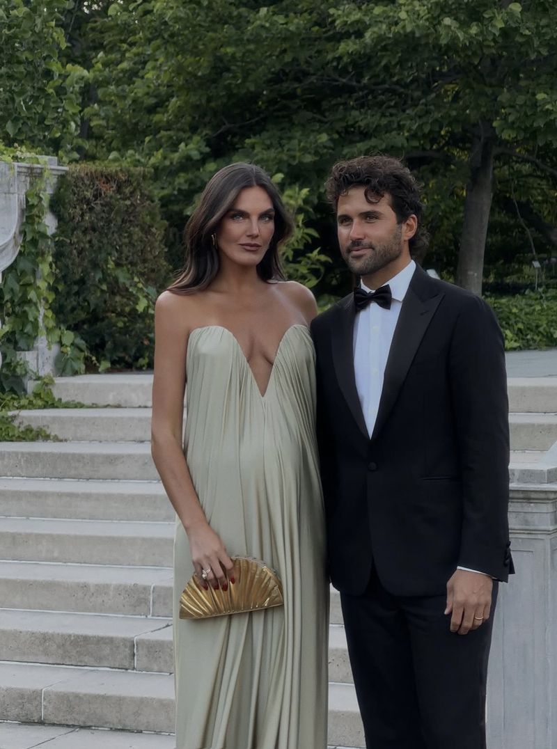 a sage strapless gown beside a classic dinner suit