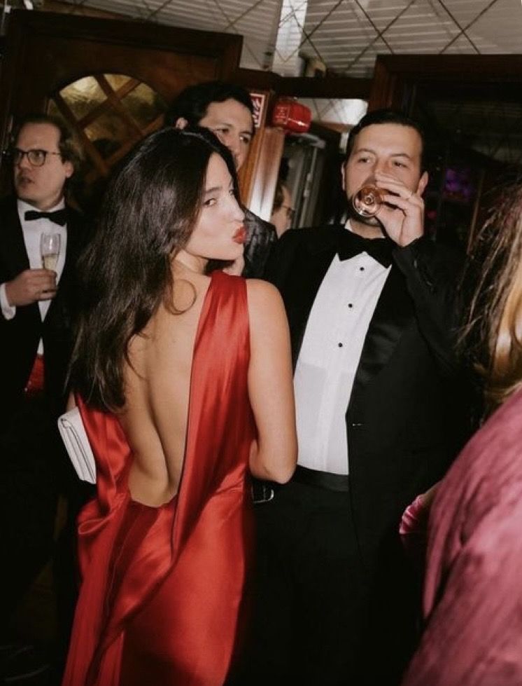 a backless scarlet silk gown at the reception
