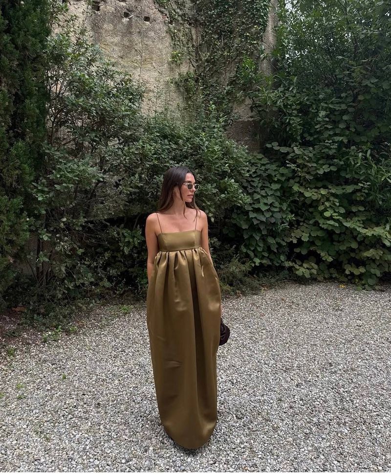an olive silk gown in a walled garden