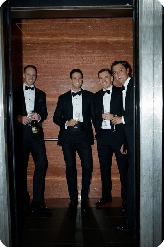 four gentlemen in black tie