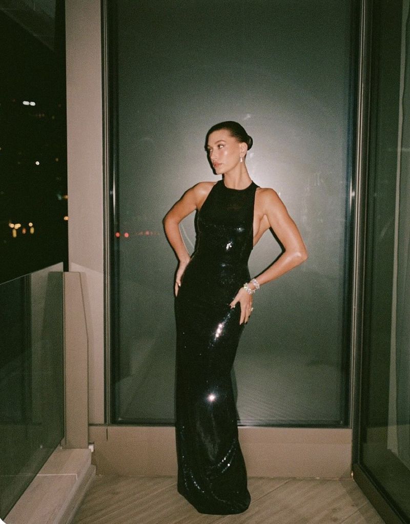a black sequin halter gown at night